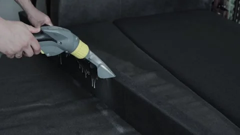 Professional dry cleaning of the sofa with a special chemical solution and a Stock Footage 243161245