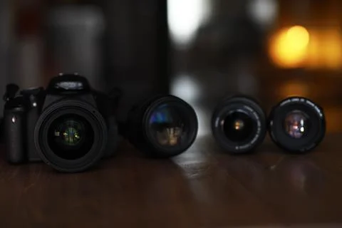 Professional DSLR Camera with Multiple Interchangeable Lenses on Wooden Surfa Stock Photos