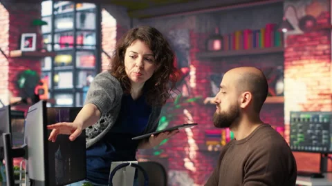 Professional editor uses AI powered software and PC reels in a creative office Stock Footage 308604493