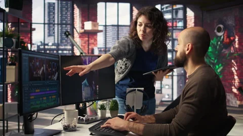 Professional editor uses AI powered software and PC reels in a creative office Stock Footage 308606311