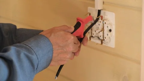 Professional electrical engineer performs installation of electrical sockets Stock Footage 110271997