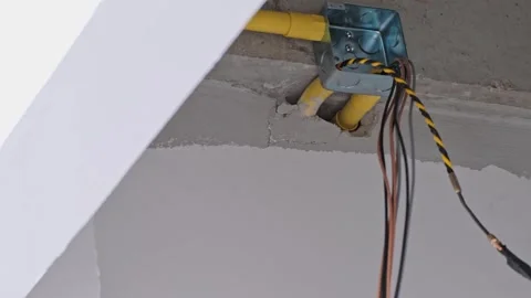 A professional electrician is expertly threading multiple colored wires thr.. Stock Footage 300072340