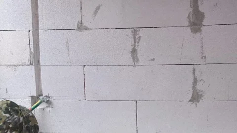 A professional electrician is expertly using a hammer to create wall openin.. Stock Footage 300075821
