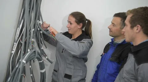 Professional electrician with students on construction site Stock Footage 45653435