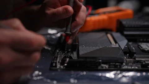 Professional electronic engineer using multimeter to measure voltage on computer Stock Footage 292006832