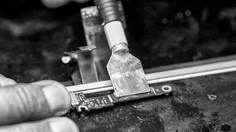 Professional electronics specialist installing replacement port on notebook.. Stock Photos