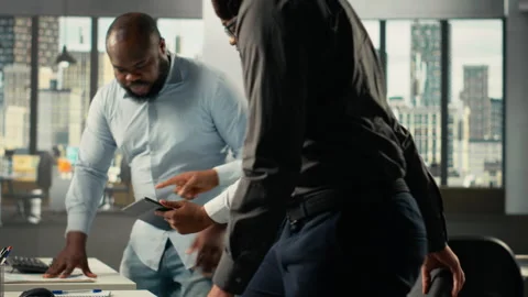 Professional employees analyzing data visualization and documentation Stock Footage 320030422