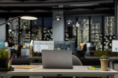 Professional empty office features laptop on desk and forecasting equipment Stock Photos
