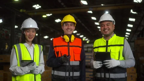 Professional engineer and worker team wearing safety helmet working in factory w Stock Footage 287472519
