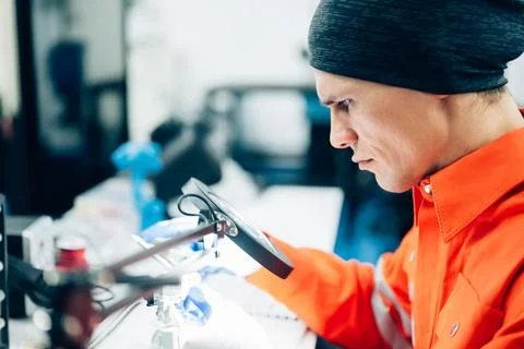 Professional engineer checking and repairing parts of robotic arm machine Stock-Fotos