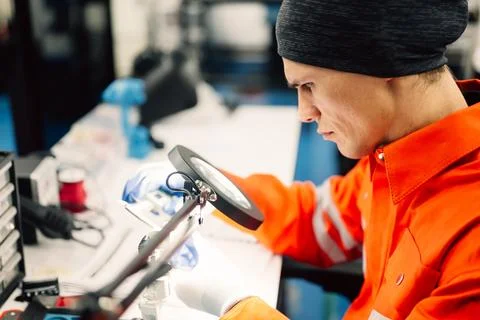 Professional engineer checking and repairing parts of robotic arm machine Stock Photos