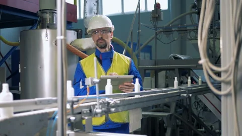 Professional engineer checking work of automated conveyor, factory machine. Stock Footage 103733489