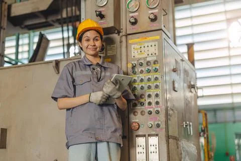Professional Engineer female worker work control operate CNC machine in hea.. 스톡 사진