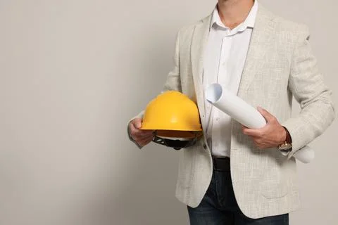 Professional engineer with hard hat and draft on white background, closeup... Stock Photos