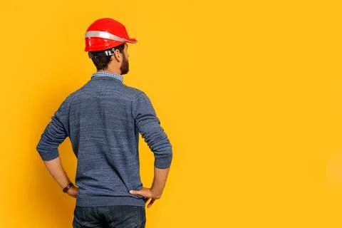 Professional engineer in hard hat on yellow background, back view. Space fo.. Foto stock