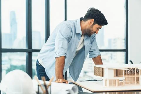 Professional engineer inspecting house model while designing building. Tracery. Stock Photos