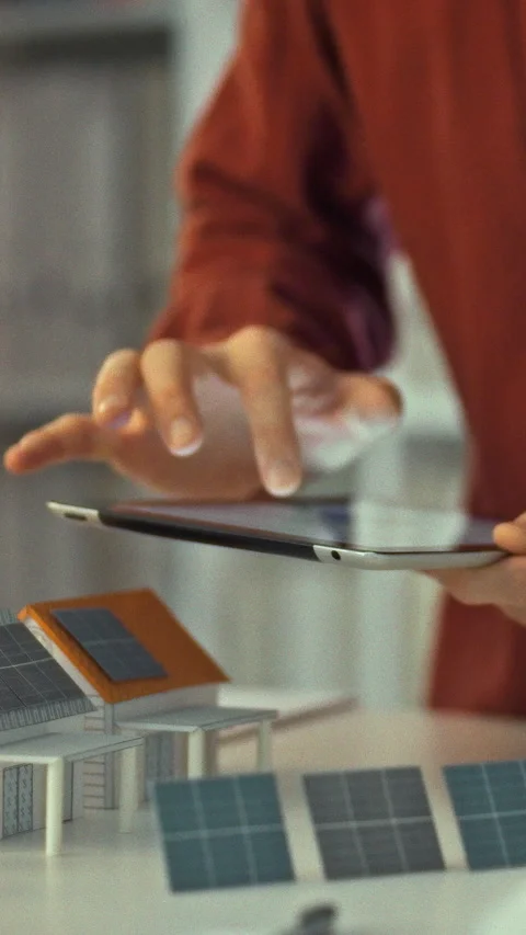A professional engineer interacts with a touchpad to assess and optimize sol Stock Footage 331529505