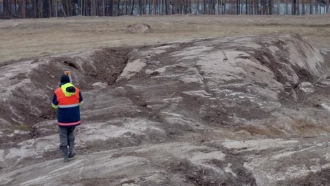 Professional engineer land surveyor in uniform works with theodolite on Stock Footage 69977230
