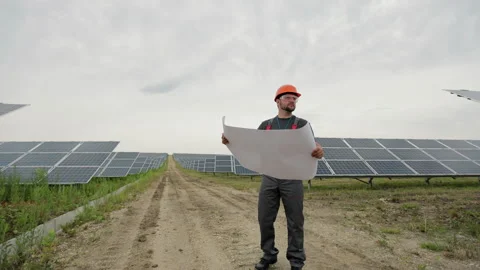 Professional engineer learning the design of the solar plant paper plan Stock Footage 156807049