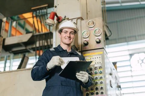 Professional Engineer male worker work control operate CNC machine in heavy.. 스톡 사진