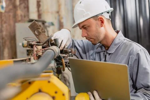 Professional engineer male worker working service inspecting robot machine,.. Stock Photos