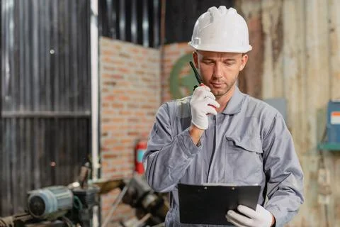 Professional engineer male worker working service inspecting robot machine,.. Stock Photos