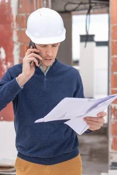 Professional engineer or architect actively managing a construction project.. 库存照片