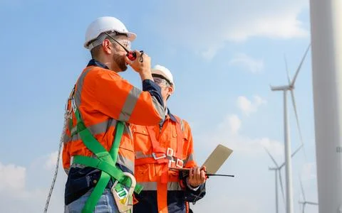 Professional engineer technician team working at wind turbine farm field 스톡 사진