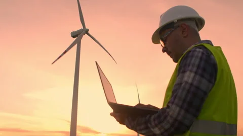 Professional engineer in uniform at a windmill checks the technical condition Stock Footage 255409435
