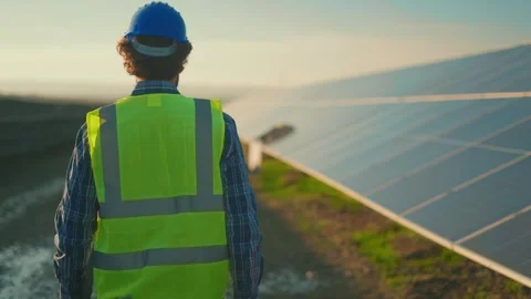 Professional engineer walking along large solar panel farm during sunset fo.. 스톡 동영상 337597894