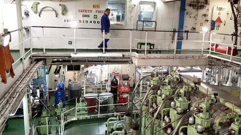 Professional engineer walks on upper ground of engine room 動画素材 116608989