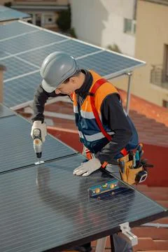 Professional engineer worker installing solar panels on a house roof Stock Photos
