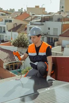 Professional engineer worker installing solar panels on a house roof Stock Photos