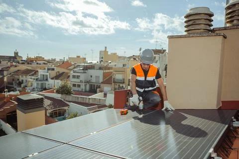 Professional engineer worker installing solar panels on a house roof Stock Photos