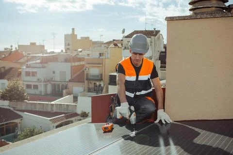 Professional engineer worker installing solar panels on a house roof Stock Photos