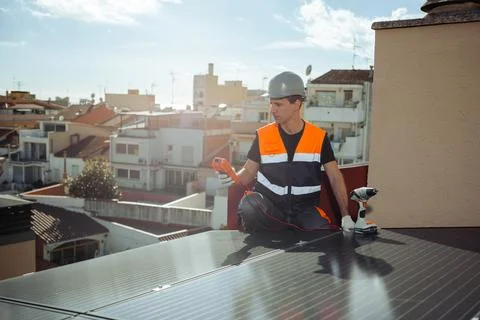 Professional engineer worker installing solar panels on a house roof Stock Photos