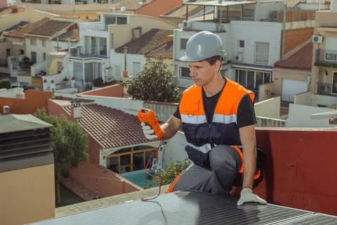 Professional engineer worker installing solar panels on a house roof Stock Photos
