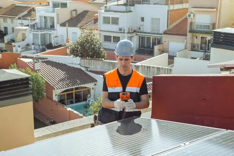 Professional engineer worker installing solar panels on a house roof Stock Photos