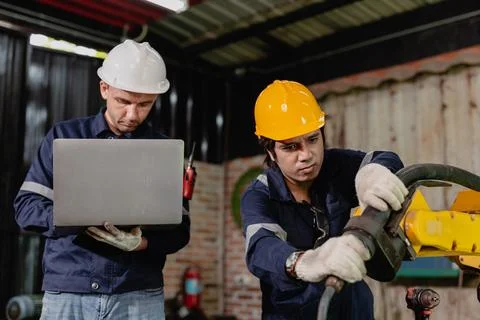 Professional engineer workers team working in metal workshop working togeth.. Stock Photos
