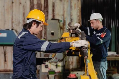 Professional engineer workers team working in metal workshop working togeth.. Stock Photos