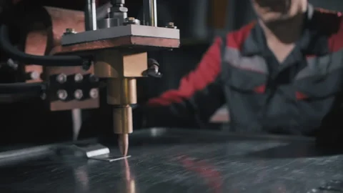 A professional engineer works with a sheet of metal. Craftsman, welder or Stock Footage 137273140