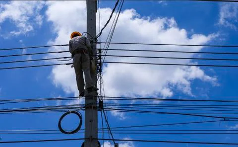 Professional engineering guy climb to high post to install and maintenance Stock Photos