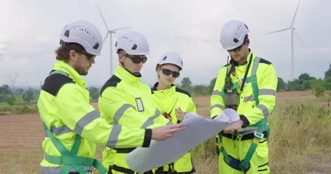 Professional engineers in bright uniform discussing blueprint for turbine 스톡 동영상 330761545