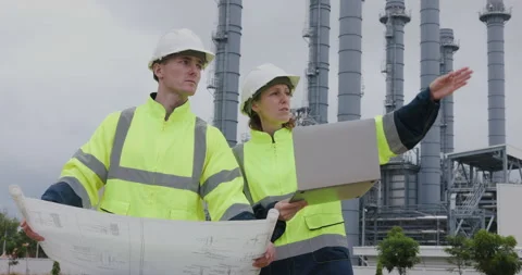 Professional Engineers Reviewing Blueprints On Digital Tablet At Industrial.. Stock Footage 336536707