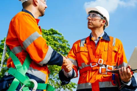 Professional engineers technicians working at wind turbine farm field Stock Photos