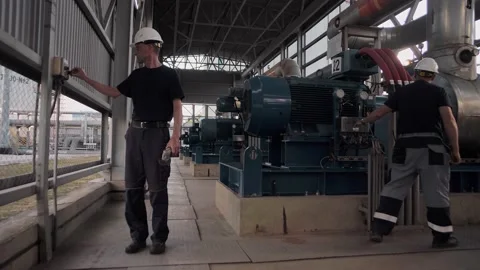 Professional engineers work at a pumping station with huge pumping units Stock Footage 212391582