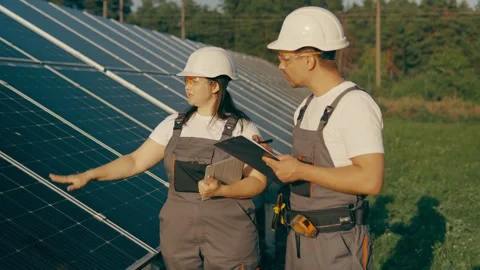 Professional engineers, workers check the operation of a solar power plant Stock Footage 256835057