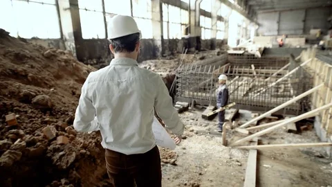 Professional engineers working together on construction site. Chief architect Stock Footage 77733092