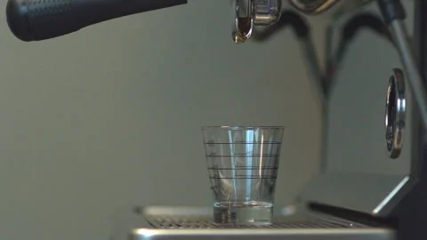 Professional espresso machine pouring strong looking fresh coffee into a measure Stock Footage 99115650
