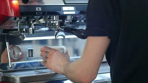 Professional espresso machine pouring strong looking fresh coffee into a neat Video stock 114324626